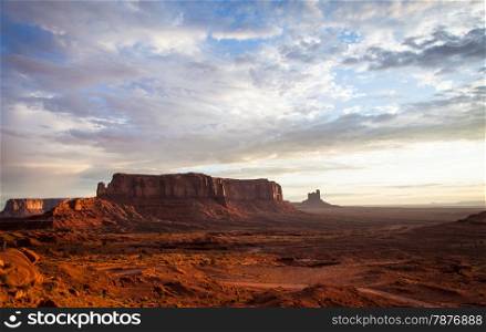 Orange colours during sunrise in this iconic view of Monument Valley, USA