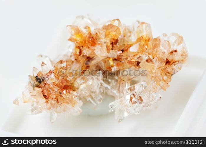 Orange Creedite crystal cluster from Mexico close-up on a white background