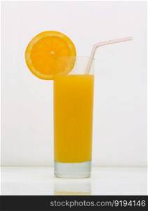 orange drink in a glass with a slice of grapefruit and straw. drink isolated on white background. fruit drinks in a glass