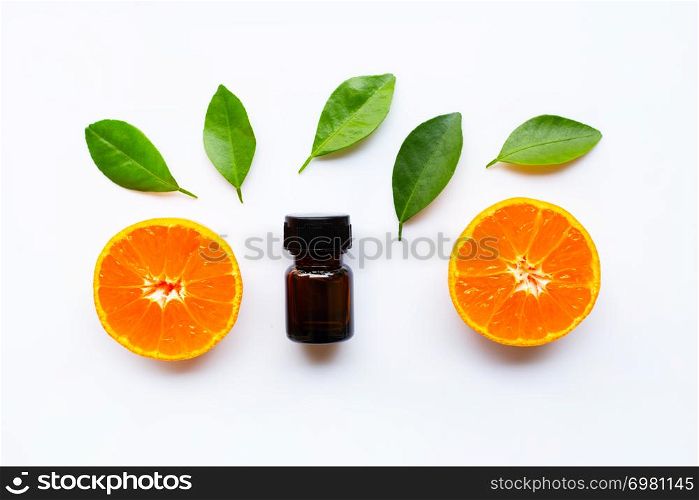 Orange essential oil with fresh fruits on white background
