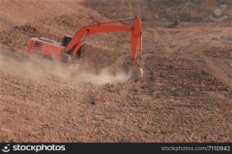 Orange excavator Under construction Large reservoir, Dust by digging the soil.