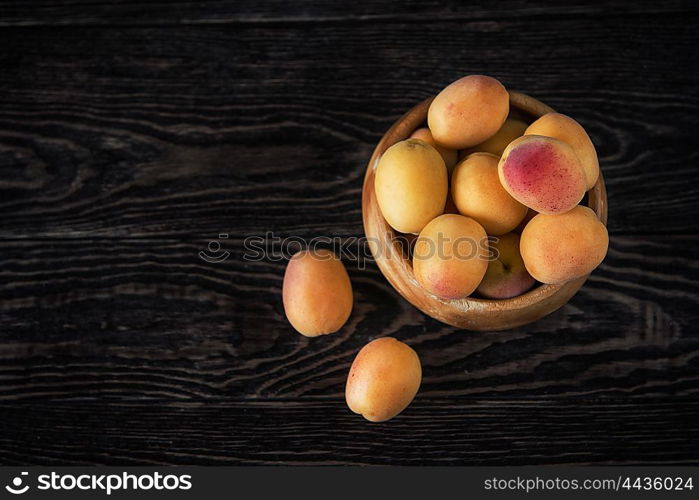 orange fresh apricots on a wooden background. orange fresh apricots