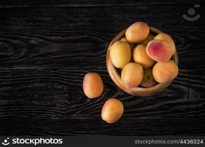 orange fresh apricots on a wooden background. orange fresh apricots
