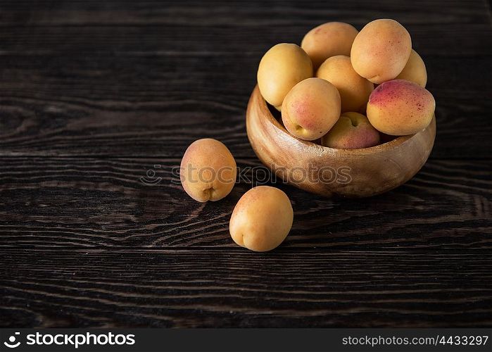 orange fresh apricots. orange fresh apricots on a wooden background