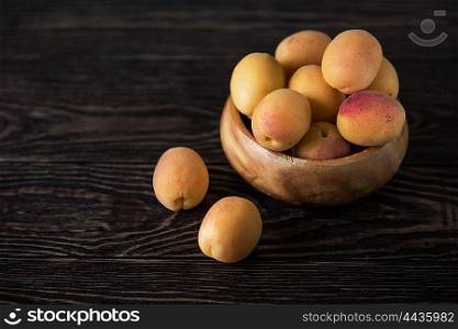 orange fresh apricots. orange fresh apricots on a wooden background