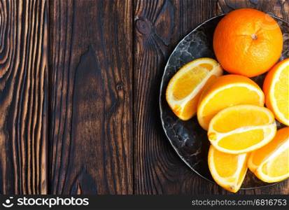 orange, fresh orange on plate and on a table