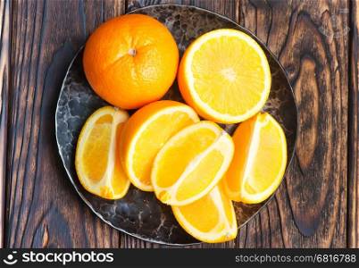 orange, fresh orange on plate and on a table