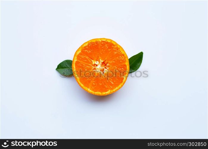Orange fruit and green leaves on a white background. Top view