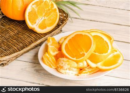 Orange fruit dish in a plate on a wooden table