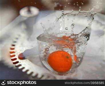 orange fruit is falling and splashing into water incolor . Concept of time