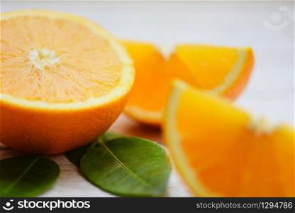 Orange fruit on wooden background / Fresh orange slice half and orange leaf healthy fruits concept , selective focus