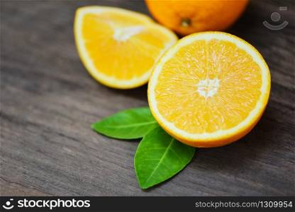 Orange fruit on wooden background / Fresh orange slice half and orange leaf healthy fruits harvest concept