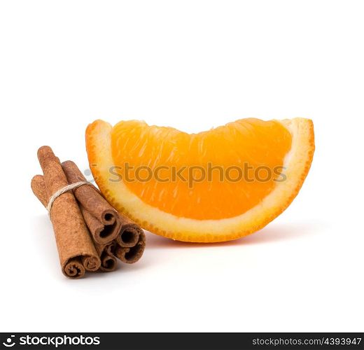 Orange fruit segment and cinnamon sticks isolated on white background. Hot drinks ingredients.