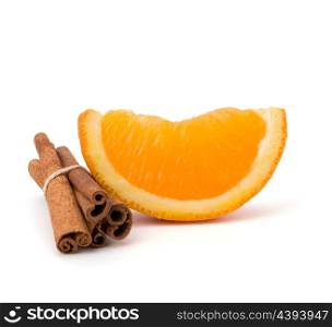 Orange fruit segment and cinnamon sticks isolated on white background. Hot drinks ingredients.