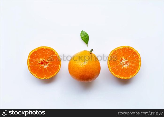Orange fruits and green leaf on a white background. Top view