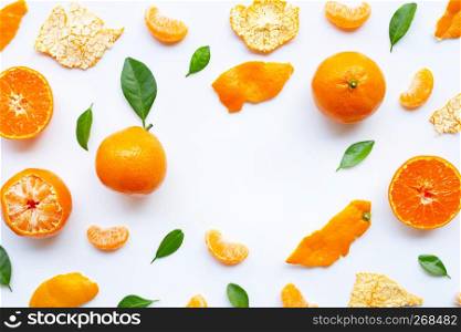 Orange fruits and green leaves on a white background. Copy space