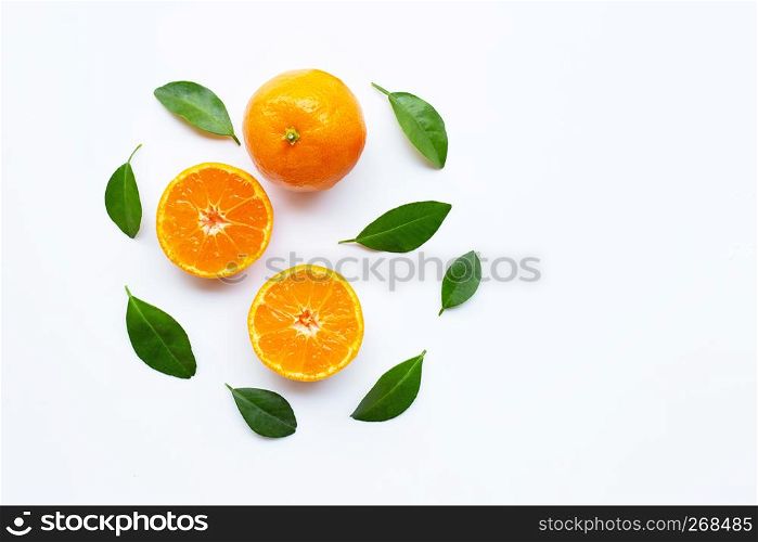 Orange fruits with leaves on white background. Top view