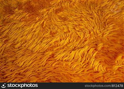 orange fur background texture, nature wool fluffy colorful close-up. orange fur background texture, nature wool fluffy colorful