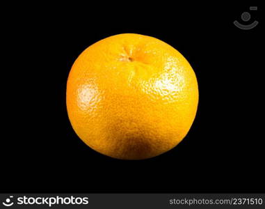 Orange grapefruit isolated on a black background. Grapefruit isolated on a black background