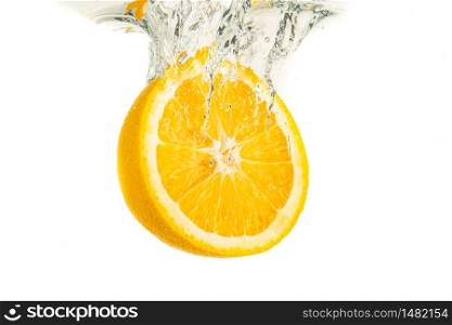 Orange half splashing into water and sinking isolated on white background. Citrus drink concept. Healthy food. Orange half splashing into water and sinking isolated on white background. Citrus drink concept.