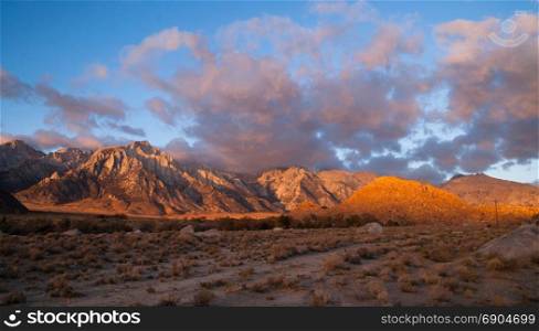 Orange hues cover mountains and clouds sunset Alabama Hills