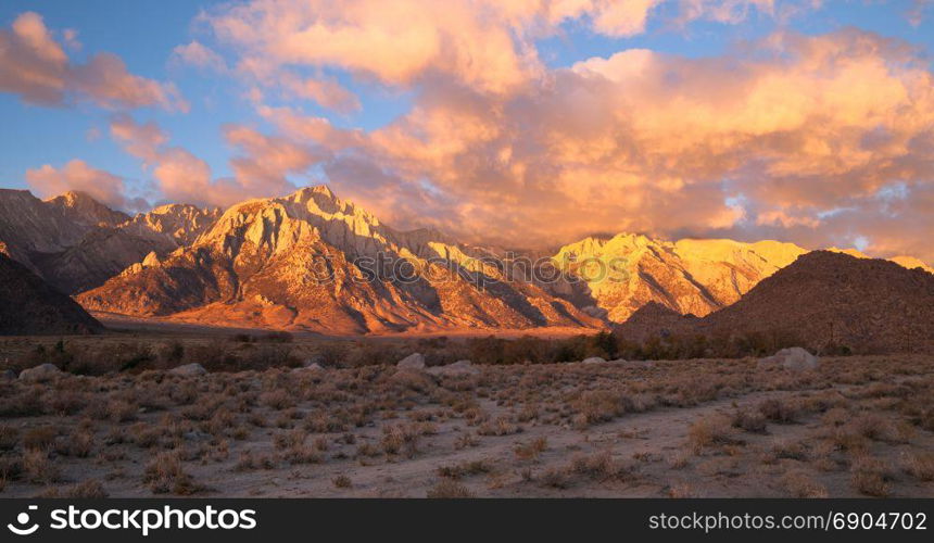 Orange hues cover mountains and clouds sunset Alabama Hills