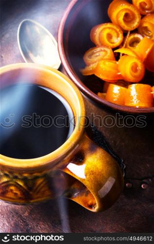Orange jam for tea. Cup of hot tea, candied orange jam