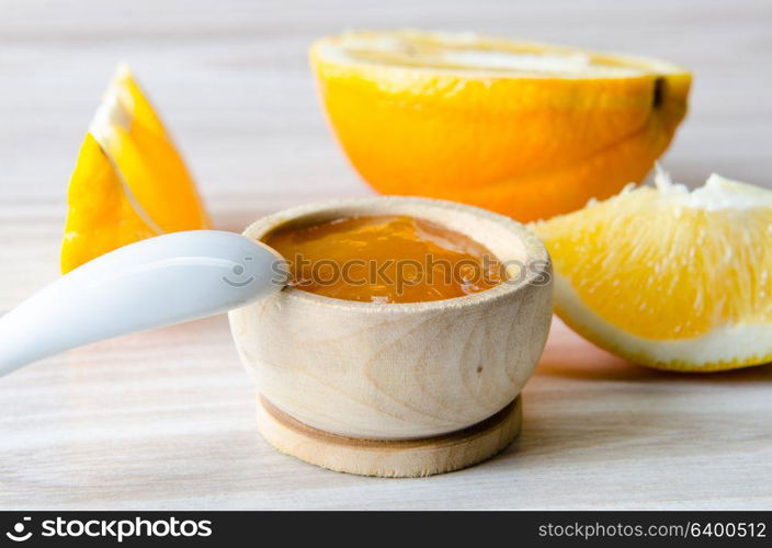 Orange jam served in spoon on the table