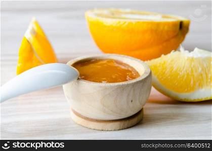 Orange jam served in spoon on the table