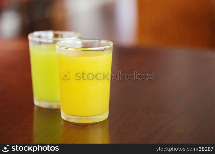 orange juice and guava juice on wood table