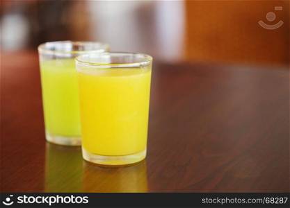orange juice and guava juice on wood table
