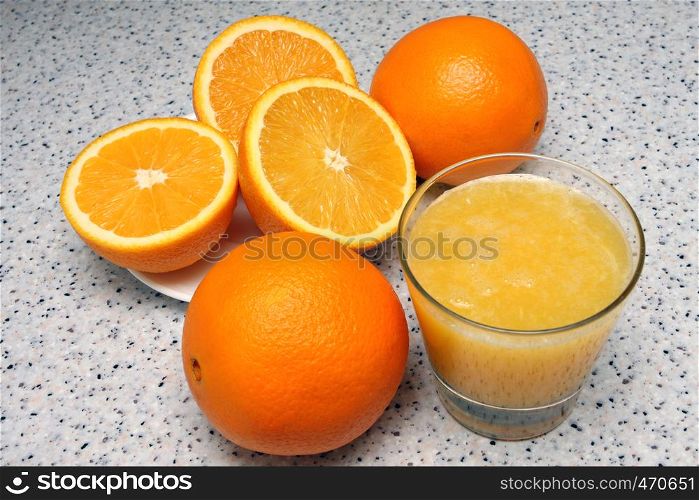 orange juice and orange on a table