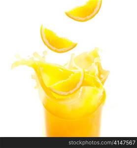 orange juice and slices are splashing in glass cut out from white background