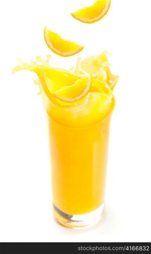 orange juice and slices are splashing in glass, cut out from white background