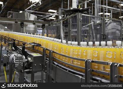 Orange juice bottles on a production line at bottle industry