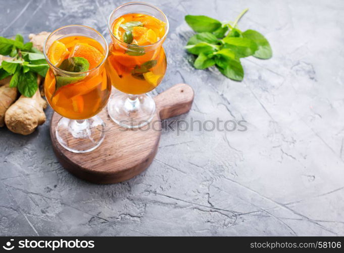 orange juice in glasses and on a table