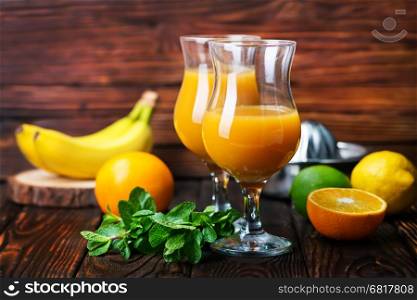 orange juice in glasses and on a table