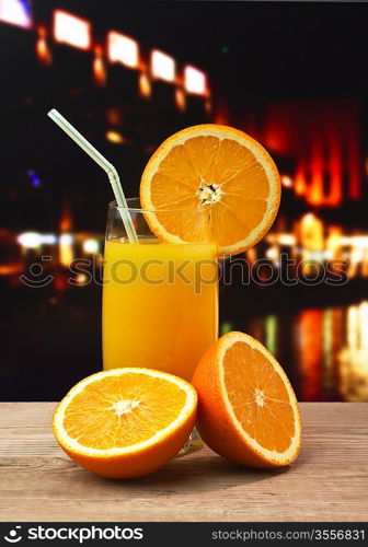 orange juice on the table night in a city cafe