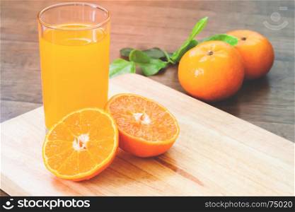 Orange juice with fresh oranges on wood table, Autumn and fall season