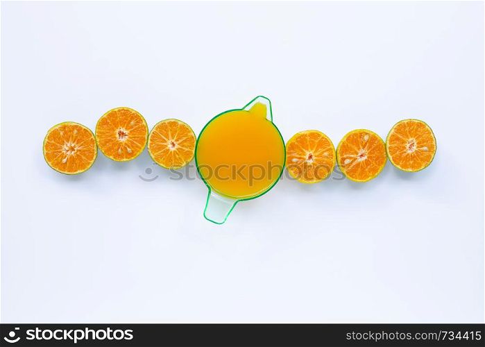 Orange juice with half-cut oranges on white background. Copy space