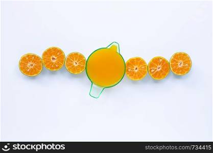 Orange juice with half-cut oranges on white background. Copy space