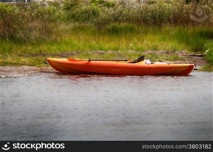 orange kayak on pamlino sound beach in north carolina