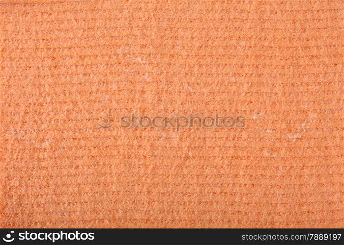 Orange kitchen sponge rubber foam as background texture