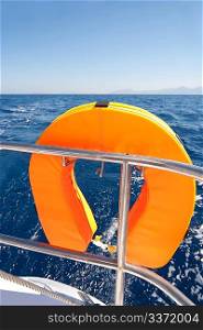 Orange lifebuoy on sailing ship and blue sea