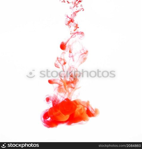 orange light ink droplet flowing water