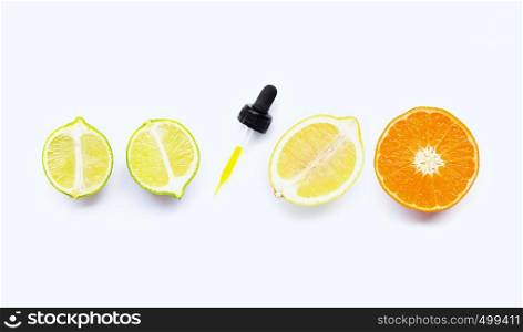 Orange, lime and lemon with dropper on white background.