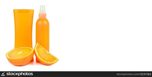 Orange natural cosmetic products: Suntan oil and lotion. Vials isolated on white background. Face and body skin care. Free space for text. Wide photo.