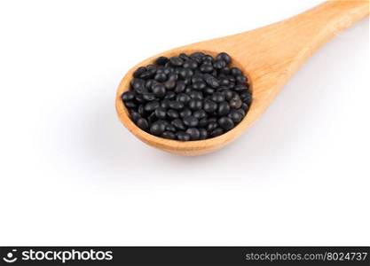 Orange organic lentils in wooden spoon isolated on white background