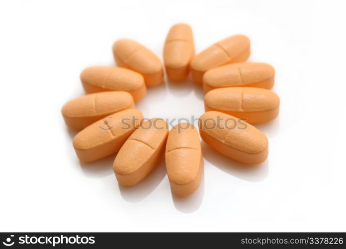 orange pills in the form of a flower isolated on white background