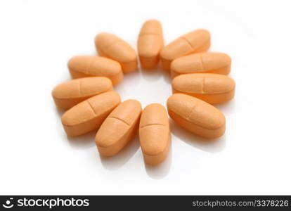 orange pills in the form of a flower isolated on white background